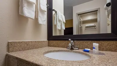 a bathroom with a sink and a mirror at Best Western Paris Inn in Paris