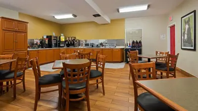 a restaurant with tables and chairs and a bar at Best Western Paris Inn in Paris
