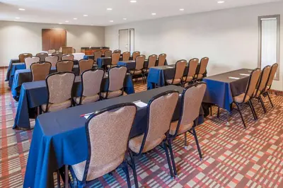 a conference room with blue tables and chairs at Wingate by Wyndham Canton-Hall of Fame in Canton