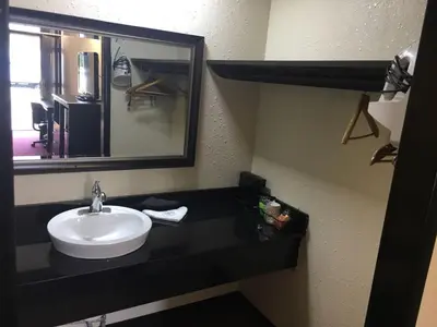 a bathroom with a sink and a mirror at Super 9 Motel Troy in Troy