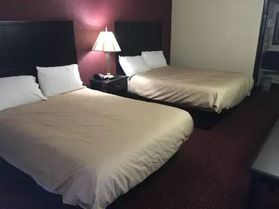 a hotel room with two beds and a lamp at Super 9 Motel Troy in Troy