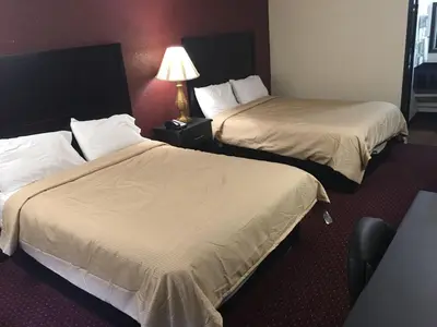 a hotel room with two beds and a lamp at Super 9 Motel Troy in Troy
