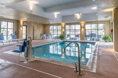 a pool in a hotel room with a swimming pool at Comfort Inn & Suites Lexington - Hamburg I-75 in Lexington