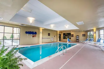 a large swimming pool in a large room with a pool at Comfort Inn & Suites Lexington - Hamburg I-75 in Lexington