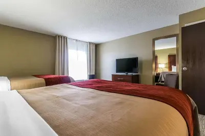 a hotel room with two beds and a television at Comfort Inn & Suites Lexington - Hamburg I-75 in Lexington