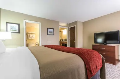 a hotel room with a bed and a flat screen tv at Comfort Inn & Suites Lexington - Hamburg I-75 in Lexington