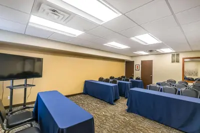 a conference room with chairs and a flat screen tv at Comfort Inn & Suites Lexington - Hamburg I-75 in Lexington