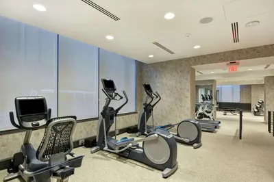 a gym with treadmills and cardio equipment in a building at The Cincinnatian Curio Collection by Hilton in Cincinnati