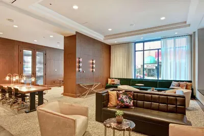 a living room with a couch and a table at The Cincinnatian Curio Collection by Hilton in Cincinnati