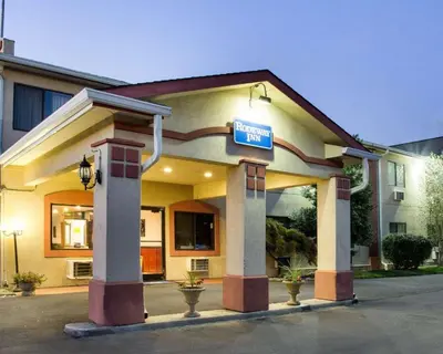 a hotel with a sign in front of it at Rodeway Inn Florence - Cincinnati South in Florence