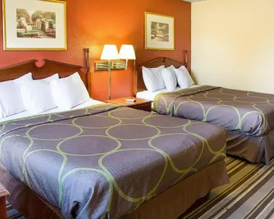 a hotel room with two beds and two lamps at Rodeway Inn Florence - Cincinnati South in Florence