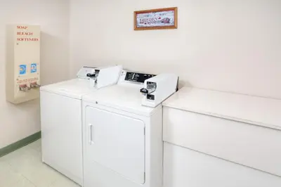 a laundry room with two washers and a machine at Super 8 by Wyndham Gas City Marion Area in Gas City