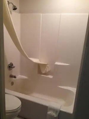 a white bathroom with a toilet and a shower at Super 8 by Wyndham Gas City Marion Area in Gas City