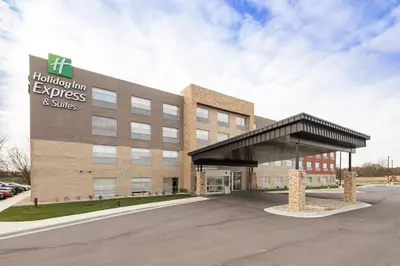 an office building with a sign that reads express and suites at Holiday Inn Express & Suites - Auburn by IHG in Auburn