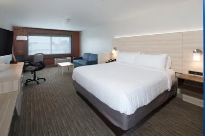 a hotel room with a large bed and a desk at Holiday Inn Express & Suites - Auburn by IHG in Auburn