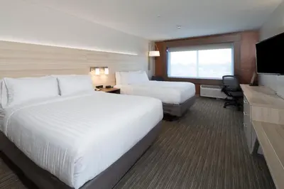 a hotel room with two beds and a television at Holiday Inn Express & Suites - Auburn by IHG in Auburn