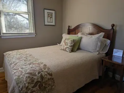 a bedroom with a bed with pillows and a window at Farrell House Lodge at Sunnybrook Trout Club in Sandusky