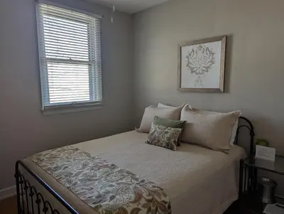a bedroom with a bed with pillows and a window at Farrell House Lodge at Sunnybrook Trout Club in Sandusky