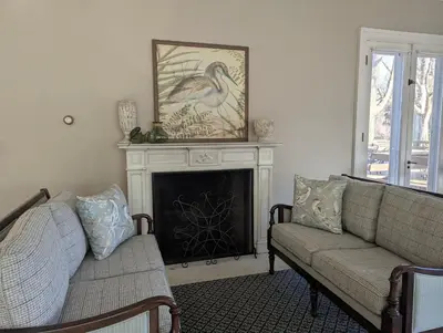 a living room with two couches and a fireplace at Farrell House Lodge at Sunnybrook Trout Club in Sandusky