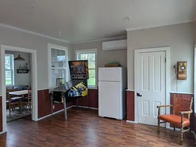 a kitchen with a white refrigerator and a table at Farrell House Lodge at Sunnybrook Trout Club in Sandusky