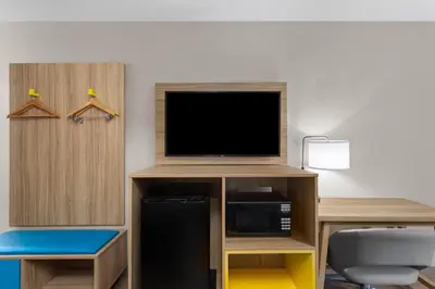 a room with a tv and a desk with a microwave at Days Inn by Wyndham Charleston WV in Charleston