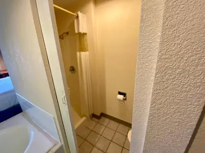 a bathroom with a shower and a toilet and a sink at Days Inn by Wyndham Morehead in Morehead
