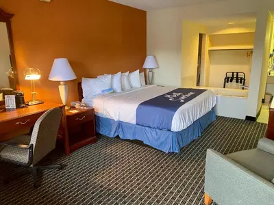 a hotel room with a bed and a desk and a room with a bed at Days Inn by Wyndham Morehead in Morehead