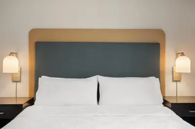 a large bed with two white pillows and two lights at Homewood Suites by Hilton Columbus/Polaris in Columbus