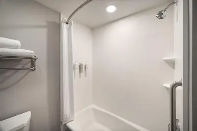 a white bathroom with a shower and a sink at Homewood Suites by Hilton Columbus/Polaris in Columbus