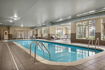 a swimming pool in a hotel room with a hotel at Homewood Suites by Hilton Columbus/Polaris in Columbus