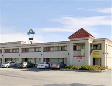 a large building with cars parked in a parking lot at Days Inn by Wyndham Mt. Sterling in Mount Sterling