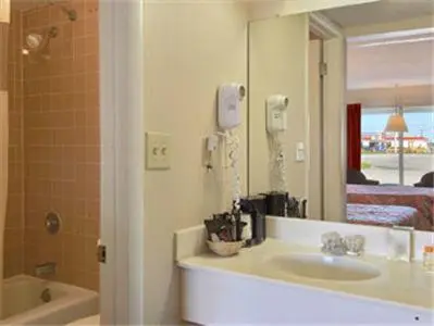 a bathroom with a sink and a mirror at Days Inn by Wyndham Mt. Sterling in Mount Sterling