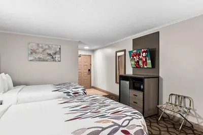 a hotel room with two beds and a tv at Red Roof Inn & Suites Lexington - Hamburg in Lexington