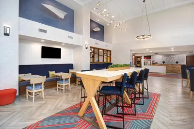 a dining room with a large table and chairs at Hampton Inn & Suites Dayton-Vandalia in Murlin Heights