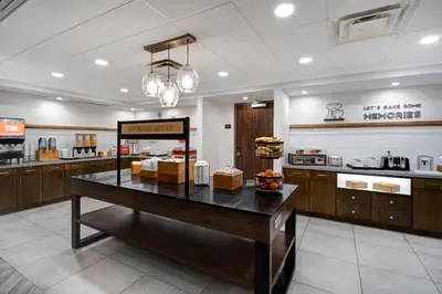 a kitchen with a table in the middle of a room at Hampton Inn & Suites Dayton-Vandalia in Murlin Heights