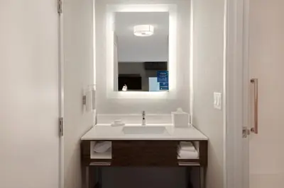 a bathroom with a sink and a mirror at Hampton Inn & Suites Dayton-Vandalia in Murlin Heights