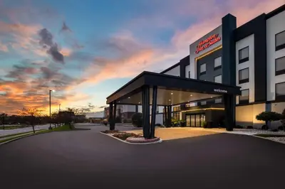 a hospital building with a sunset in the background at Hampton Inn & Suites Dayton-Vandalia in Murlin Heights