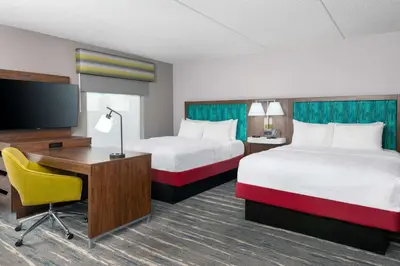 a hotel room with two beds and a desk and a tv at Hampton Inn & Suites Cleveland-Beachwood in Beachwood