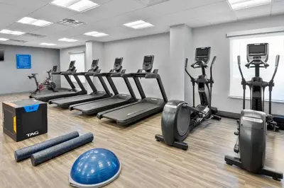 a gym with rows of treadmills and exercise bikes at Hampton Inn & Suites Cleveland-Beachwood in Beachwood