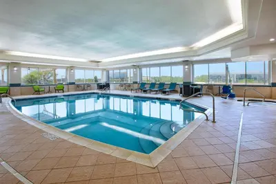 a pool in the middle of a room with chairs and tables at Hampton Inn & Suites Cleveland-Beachwood in Beachwood