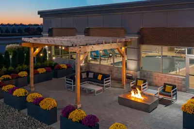 a patio with a fire pit and a building at Hampton Inn & Suites Cleveland-Beachwood in Beachwood