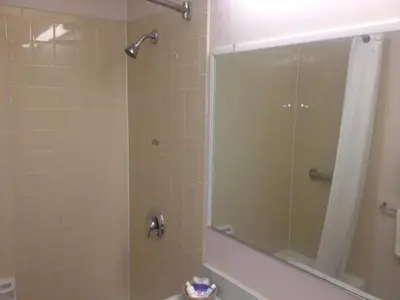 a bathroom with a shower with a glass door at Richmond Inn and Suites in Richmond
