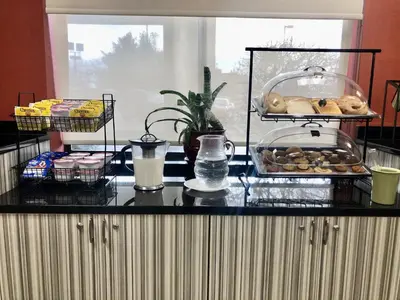a counter with some pastries and other food on it at Ramada Limited - Mount Sterling in Mount Sterling