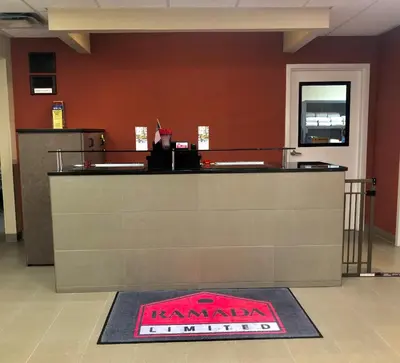 a restaurant counter with a sign on the floor at Ramada Limited - Mount Sterling in Mount Sterling