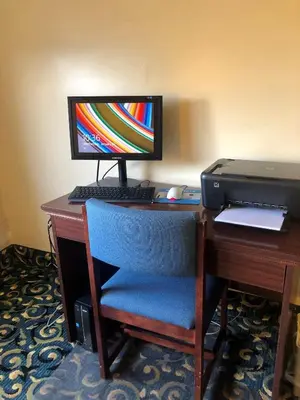 a desk with a computer monitor and a printer at Ramada Limited - Mount Sterling in Mount Sterling