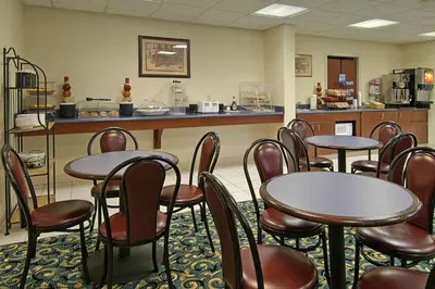 a restaurant with tables and chairs and a counter at Ramada Limited - Mount Sterling in Mount Sterling