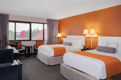 a hotel room with two beds and a television at Howard Johnson by Wyndham Lima in Lima