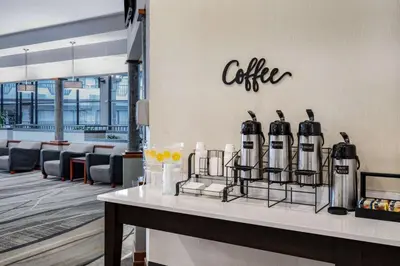 a counter with bottles of coffee on a wall at Howard Johnson by Wyndham Lima in Lima