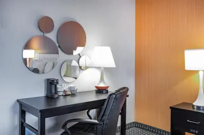 a hotel room with a desk and two mirrors at Howard Johnson by Wyndham Lima in Lima