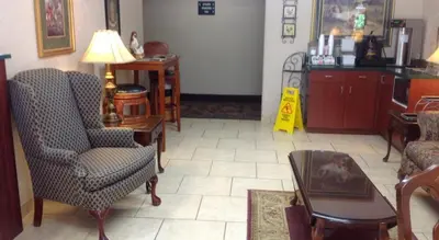 a living room with a chair and a table at Brookshire Inn in Inez